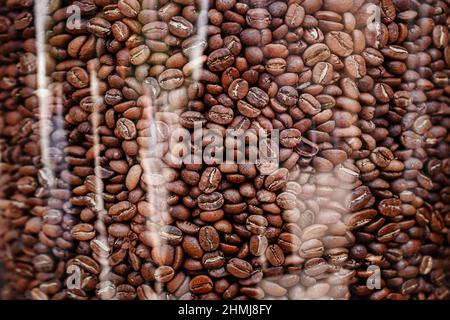 coffee beans pattern. roasted coffee beans in glass jar. coffee beans background. endless coffee texture. seamless background. Stock Photo