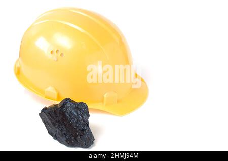 Mining helmet and piece of coal on white background.Mining production. Stock Photo