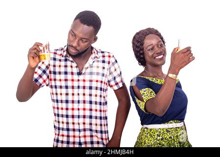 young people standing on white background looking at glasses of beer smiling. Stock Photo