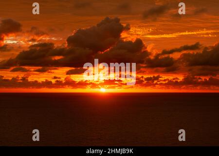 Seascape with dramatic red clouds sky at sunset. Stock Photo
