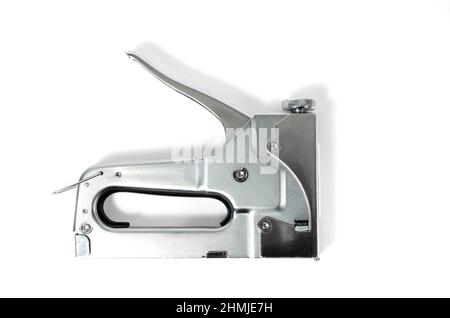 Metal Nickel plated stapler gun on white background, isolate close up. Stock Photo