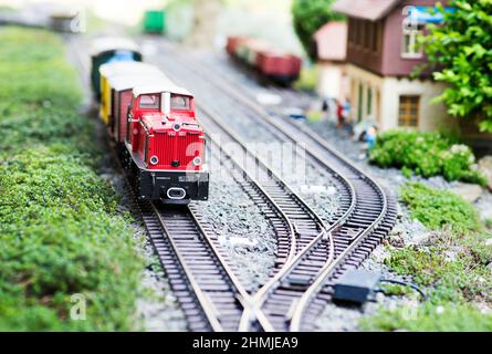 Miniature train railway model set by a station Stock Photo