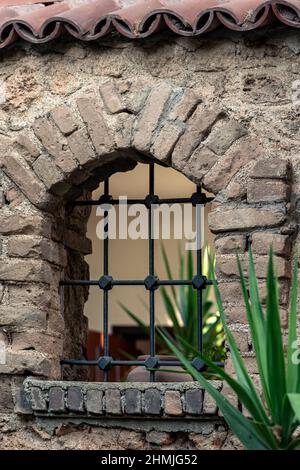 architecture in historic city center of Antalya, lattice window in a stone fence with a tiled roof Stock Photo