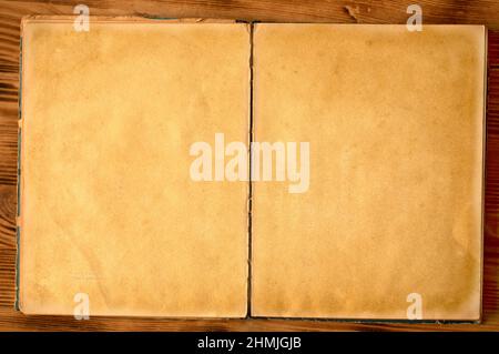 An old unfolded, tattered and yellowed book with blank pages. Stock Photo