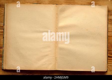 An old unfolded, tattered and yellowed book with blank pages. Stock Photo