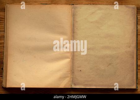 An old unfolded, tattered and yellowed book with blank pages. Stock Photo