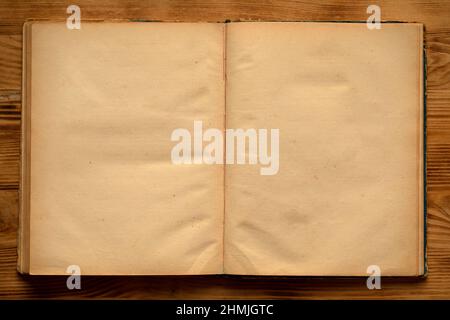 An old unfolded, tattered and yellowed book with blank pages. Stock Photo