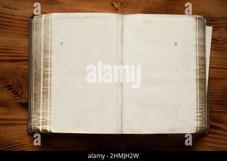 An old unfolded, tattered and yellowed book with blank pages. Stock Photo