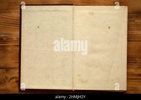 An old unfolded, tattered and yellowed book with blank pages. Stock Photo