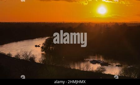 London, UK. 10th Feb, 2022. The sun sets slowly over the River Thames and Richmond, tinting the sky bright orange at the end of a cold but sunny day in Southwest London Credit: Imageplotter/Alamy Live News Stock Photo