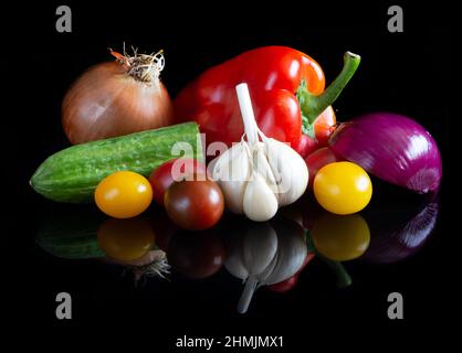Different vegetables on reflective black background Stock Photo