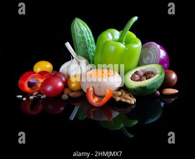 Different vegetables on reflective black background Stock Photo