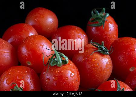 Cherry tomatoes on black background Stock Photo
