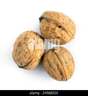 Whole solid walnuts on white background Stock Photo