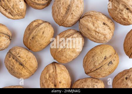 Whole solid walnuts on white background Stock Photo