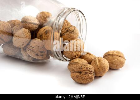Whole solid walnuts in a jar on white background Stock Photo
