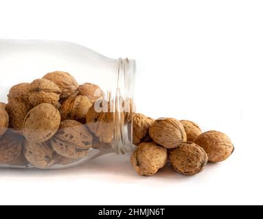 Whole solid walnuts in a jar on white background Stock Photo