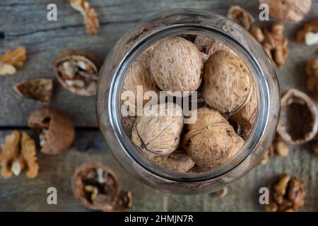 Whole solid walnuts in a jar top view Stock Photo