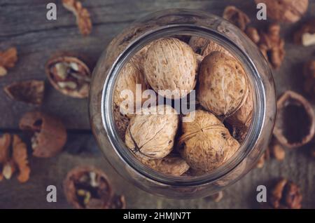 Whole solid walnuts in a jar top view Stock Photo