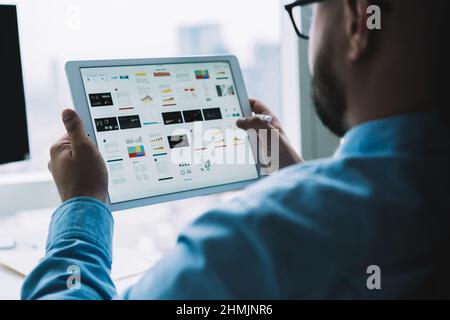 Man using tablet with diagrams and graphics Stock Photo