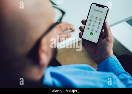 Crop unrecognizable man using modern smartphone Stock Photo