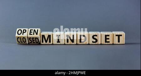 Open or closed mindset symbol. Turned wooden cubes and changed concept words closed mindset to open mindset. Beautiful grey background, copy space. Bu Stock Photo