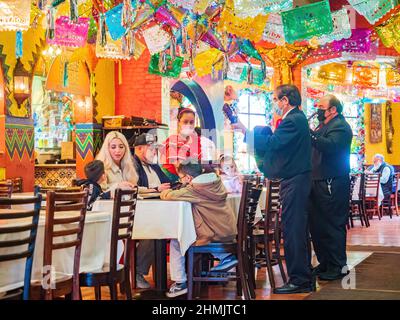 Texas, FEB 2 2022 - People doing musical performance in the El Mercado Snack Bar Stock Photo