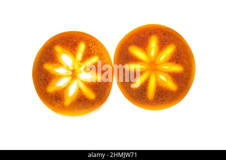 Close-up of two pieces of ripe persimmon, two round slices on an isolated white background. Bright light in the middle of the fruit. Full depth of field. High quality photo