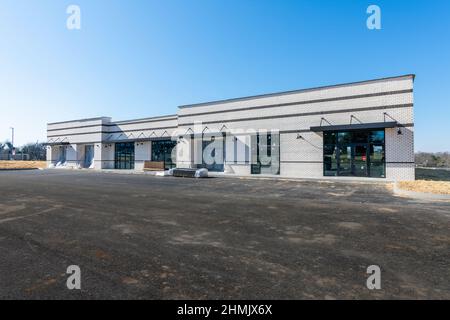 Horizontal shot of a new business strip shopping center being built. Stock Photo