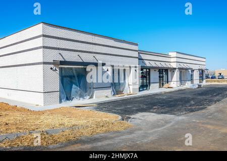 Horizontal shot of new construction of a small retail strip shopping center. Stock Photo