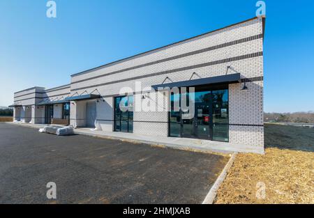 Horizontal shot of new retail construction on a small shopping center with copy space. Stock Photo