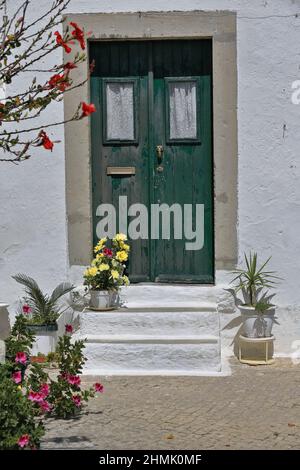 Green wood door-chipped paint-three doorsteps-Hermitage of Saint Blaise. Tavira-Portugal-105 Stock Photo