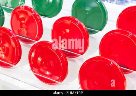 Bright red and green tin screw caps for glass jar background Stock Photo