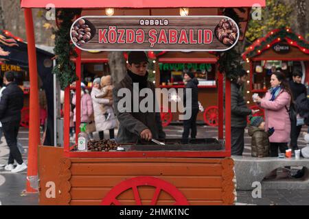 Baku, Azerbaijan - January 03 2022-  Roasted chestnut cart with seller Stock Photo