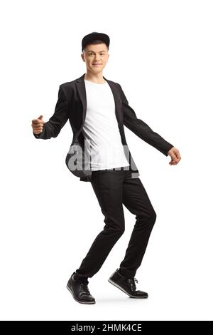Full length portrait of a guy in a suit and black hat dancing isolated on white background Stock Photo