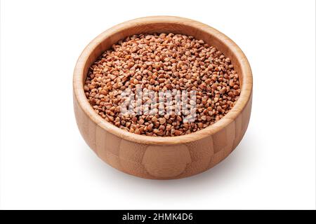 Buckwheat grains, seeds in wooden bowl isolated on white background. Stock Photo