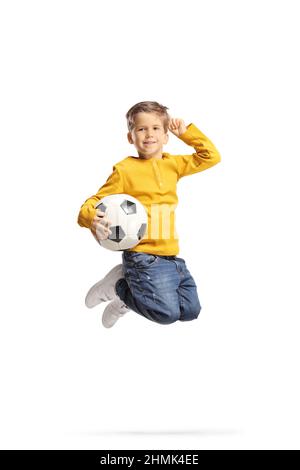 Full length shot of a boy holding a football and jumping isolated on white background Stock Photo