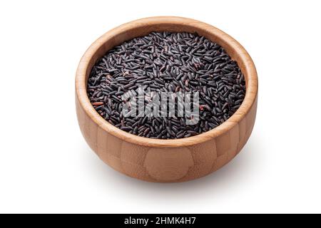 Black basmati rice in wooden bowl isolated on white background. Stock Photo