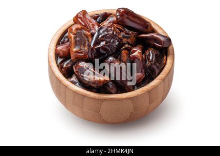 Dried dates in woodem bowl isolated on a white background Stock Photo