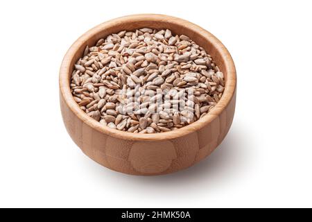 Raw sunflower seeds in wooden bowl isolated on white background. Stock Photo