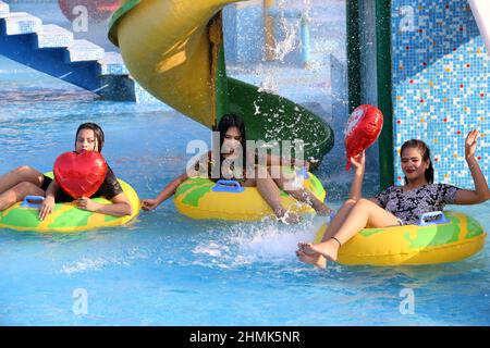 Two cool young girls wearing bikini pose in the pool in the water park.  7219085 Stock Photo at Vecteezy