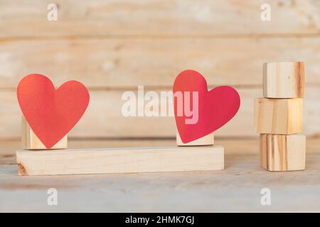 wooden blocks with red hearts, on wooden background Stock Photo