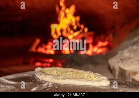 Turkish cuisine, pita bread in stone brick natural flame oven on wooden  board, fresh hot baked loaf, copy space. Bakery or bakehouse concept image  Stock Photo - Alamy
