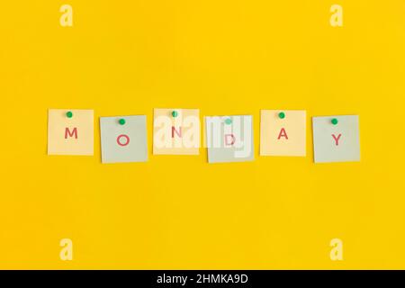 Sticky note with text Monday on yellow background Stock Photo