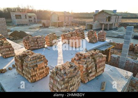 Industrial building site in rural area with residential houses under construction for future sale or leasing. Concept of real estate development. Stock Photo
