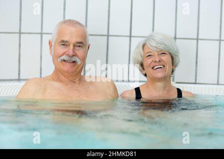 happy healthy senior couple having fun together in jacuzzi Stock Photo