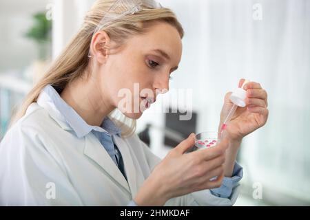 young female scientist loads samples for dna amplification Stock Photo