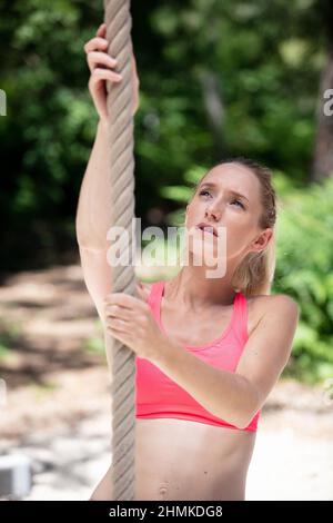 fitness rope climb exercise in fitness gym workout Stock Photo