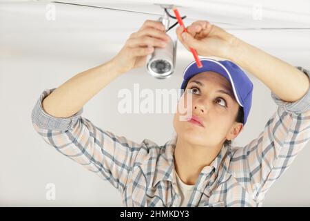 pretty female cctv installing cctv Stock Photo