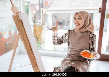 muslim artist painter thinking about what to paint Stock Photo